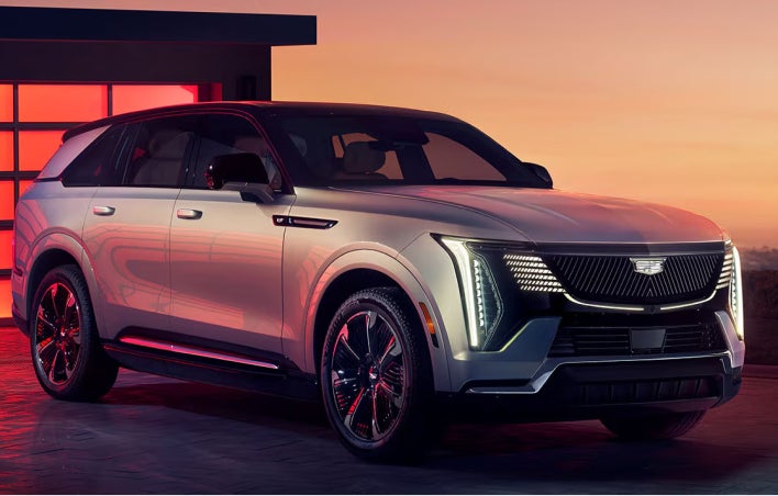 Silver Cadillac SUV parked in the driveway
