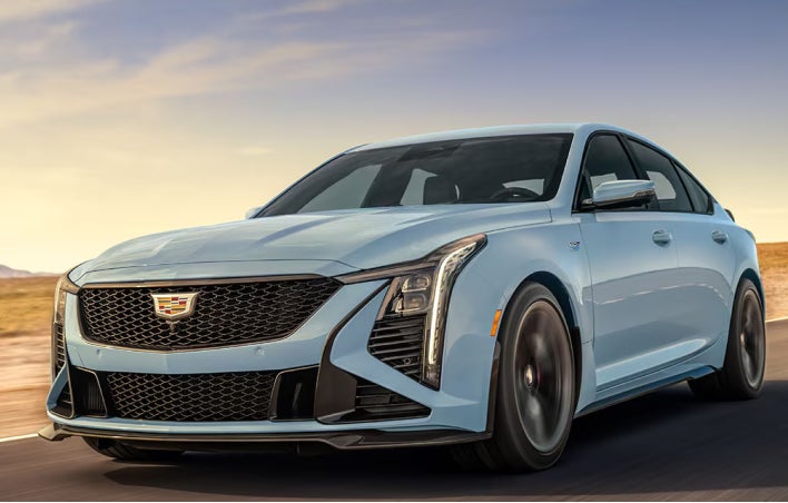 Baby Blue Cadillac Sedan driving through the desert highway