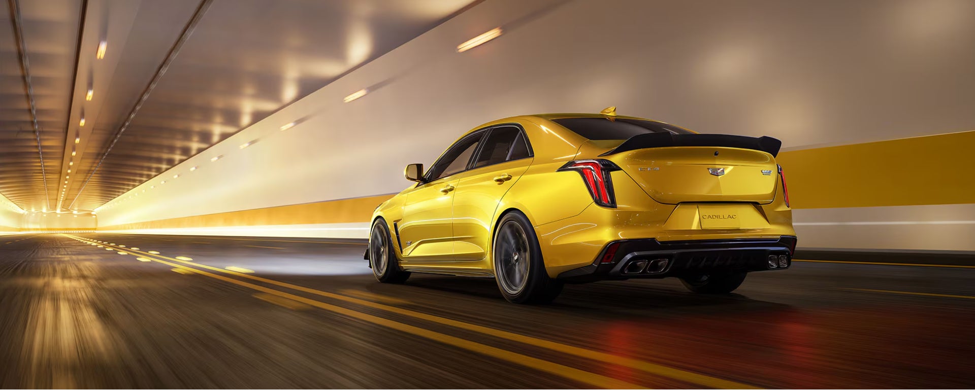 Yellow Cadillac Sedan driving in a tunnel